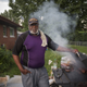 Donald Harry, 57, a home owner, poses for a portrait while grilling in his backyard.